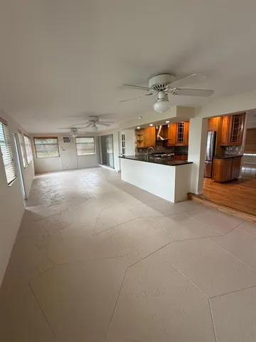 an empty room with windows and fireplace