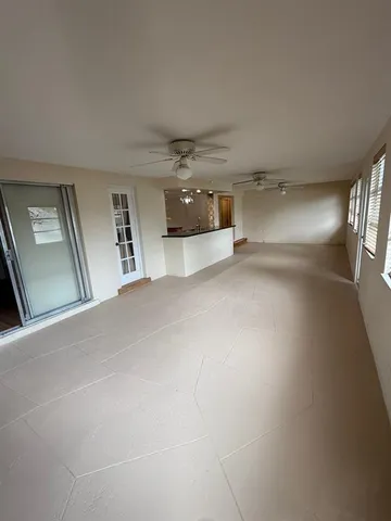 a large kitchen with stainless steel appliances wooden floors and wooden cabinets