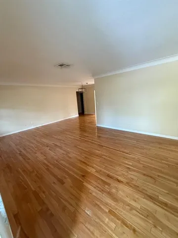a view of an empty room and wooden floor
