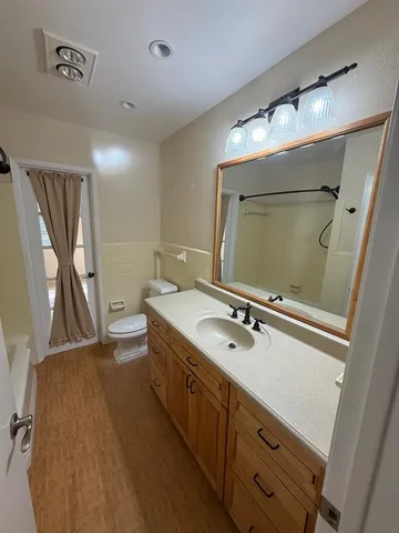a bathroom with a double vanity sink and mirror