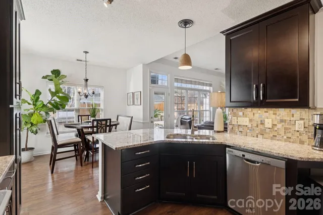 a kitchen with a sink cabinets and wooden floor
