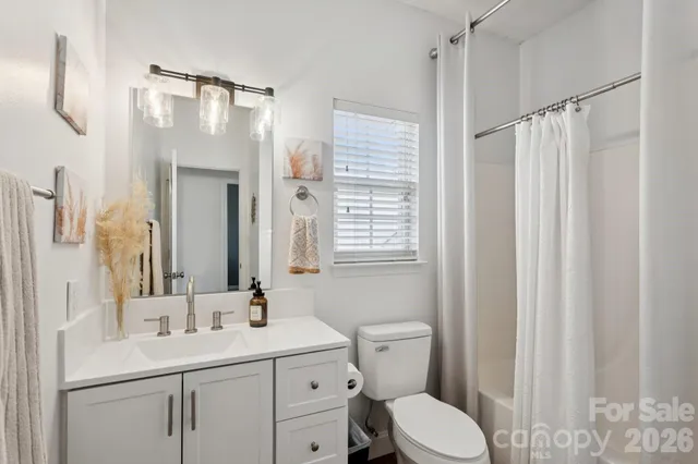 a bathroom with a toilet a sink and a mirror
