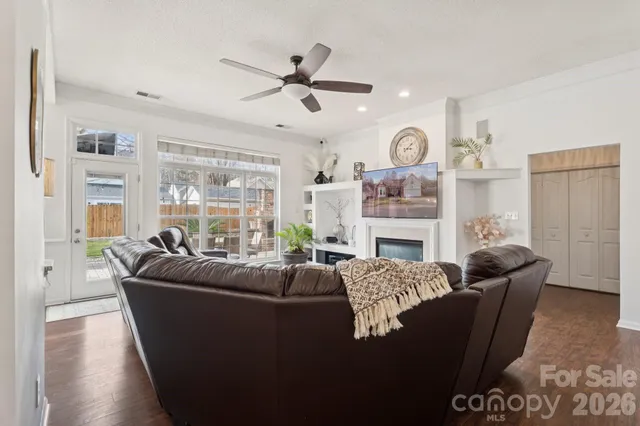 a living room with fireplace furniture and a large window