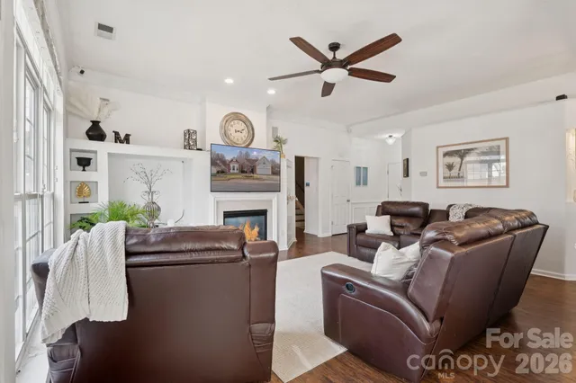 a living room with furniture a window and a fireplace