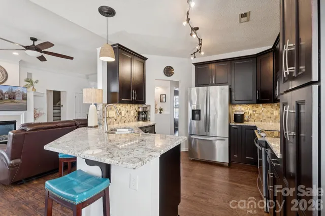 a kitchen with refrigerator cabinets and wooden floor