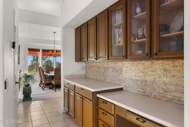 a kitchen with stainless steel appliances kitchen island granite countertop a table and chairs in it