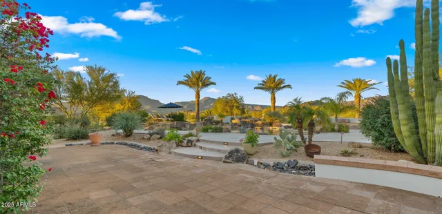 an aerial view of a house with a yard and swimming pool