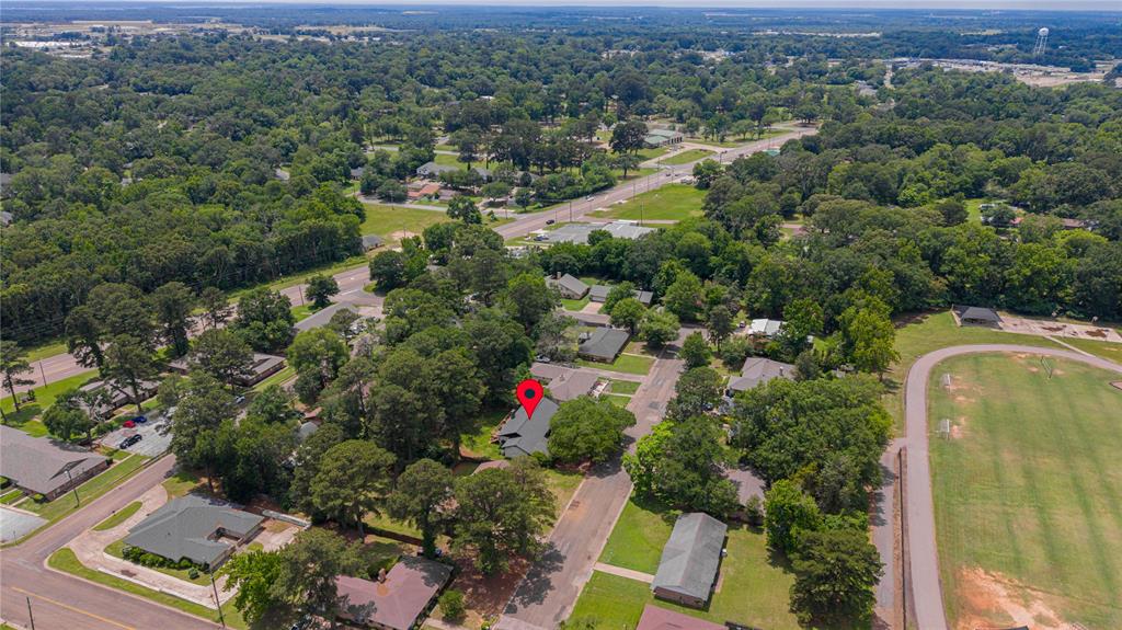 1006 Rikkity Lane Mount Pleasant, TX 75455 - Photo 35 of 39 an aerial view of residential house with outdoor space and swimming pool