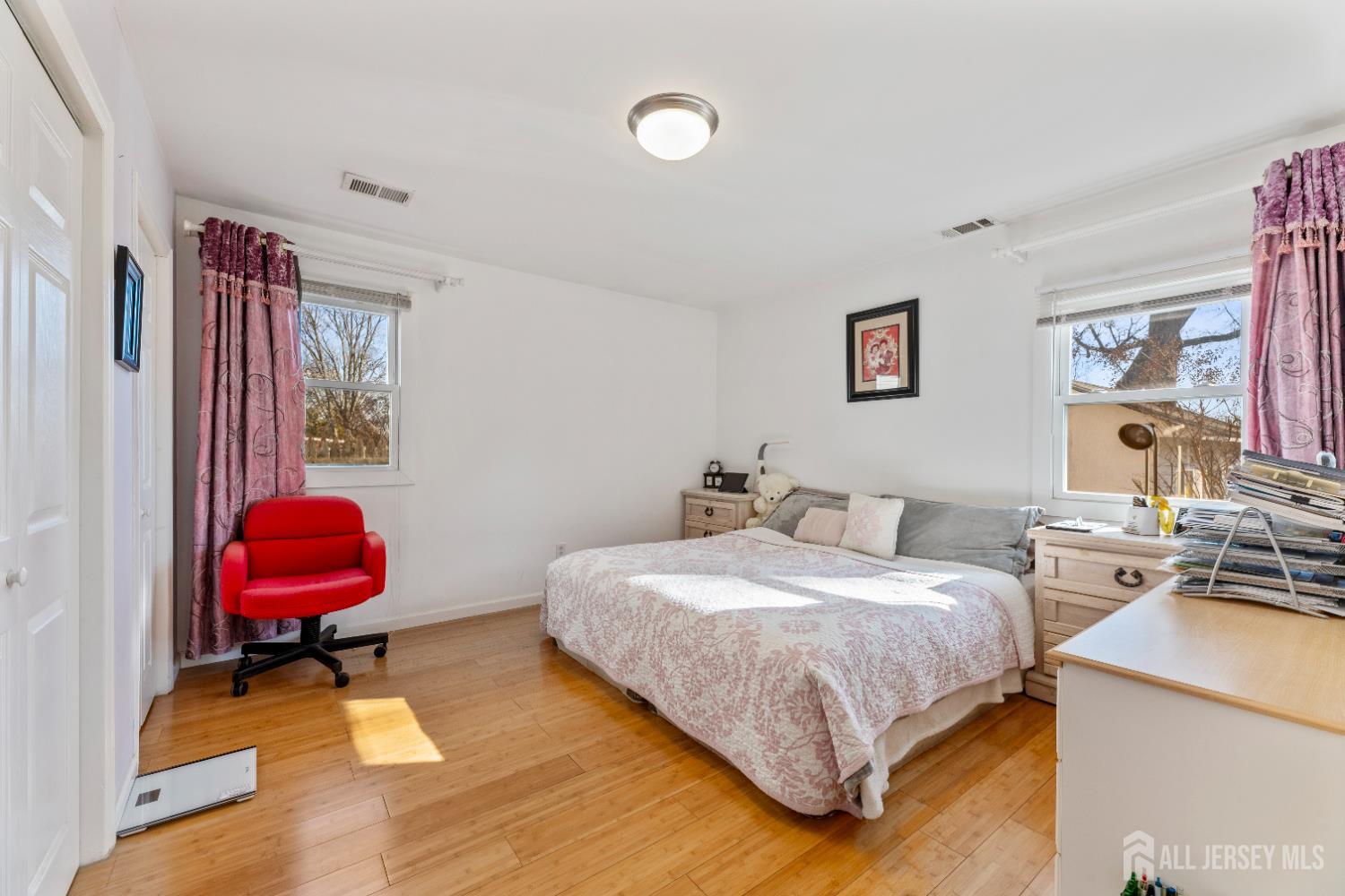 46 Runyon Avenue Edison, NJ 08817 - Photo 15 of 48 a bedroom with a bed a rug and a window