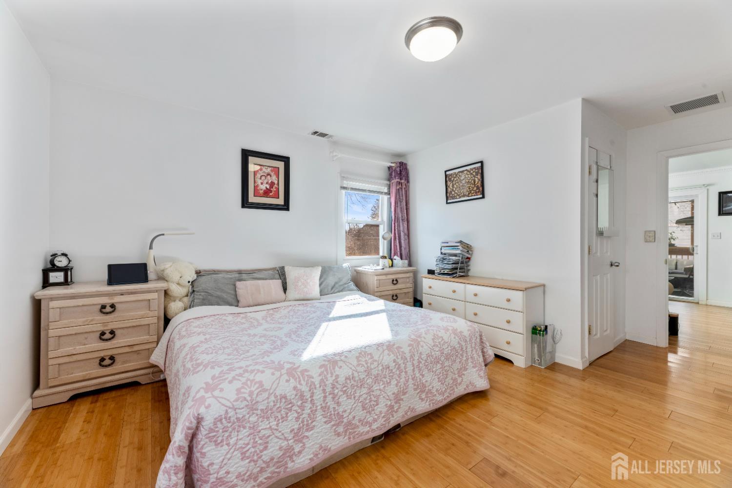 46 Runyon Avenue Edison, NJ 08817 - Photo 17 of 48 a bedroom with a bed and wooden floor