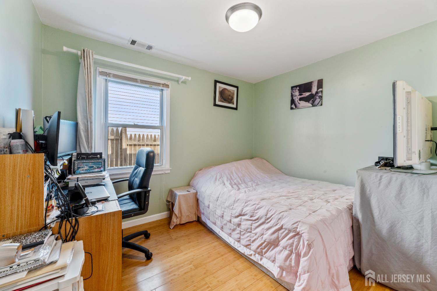 46 Runyon Avenue Edison, NJ 08817 - Photo 21 of 48 a bedroom with a bed and wooden floor