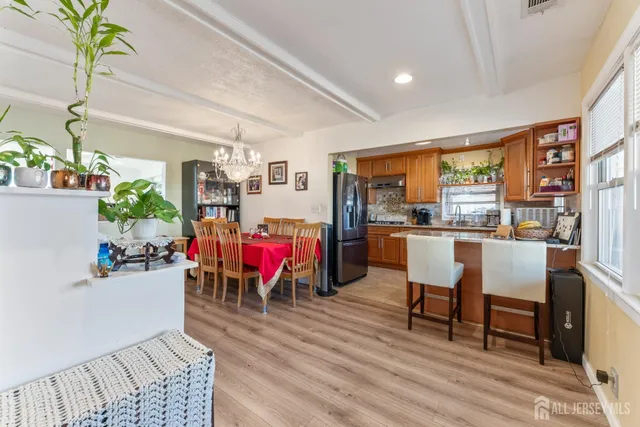 a living room with dining room and wooden floor