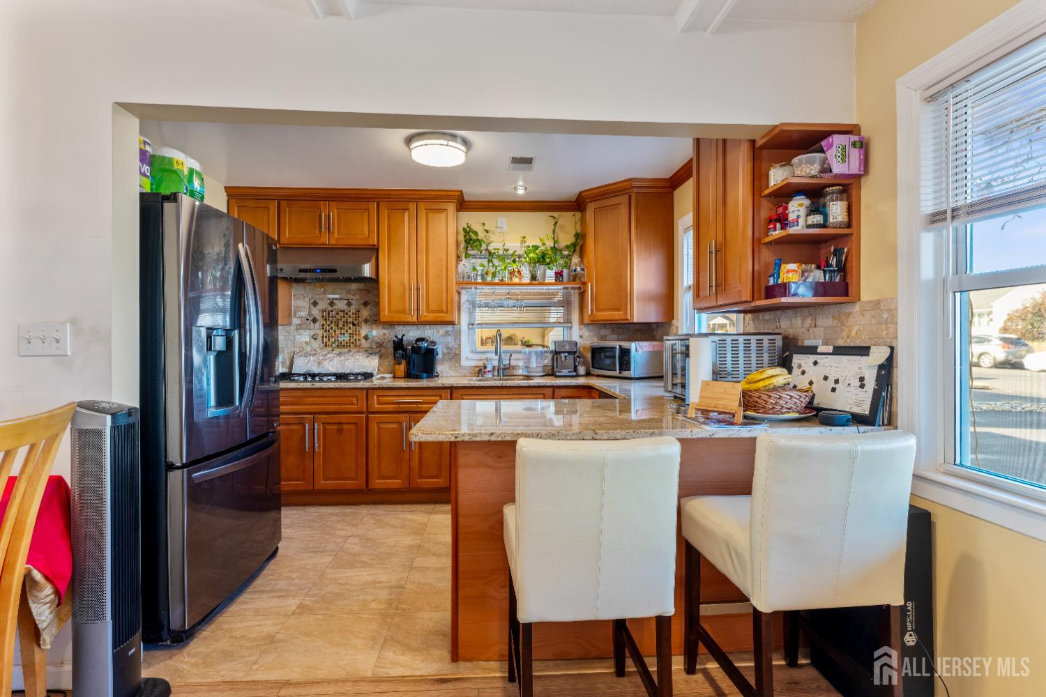 46 Runyon Avenue Edison, NJ 08817 - Photo 5 of 48 a kitchen with stainless steel appliances granite countertop a refrigerator a stove and a dining table with wooden floor