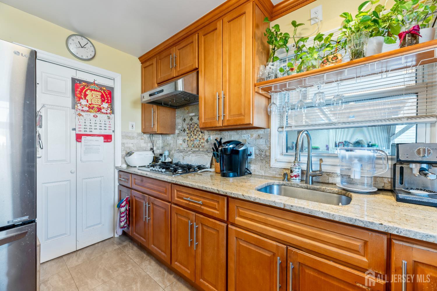 46 Runyon Avenue Edison, NJ 08817 - Photo 7 of 48 a kitchen with stainless steel appliances granite countertop a sink and a refrigerator