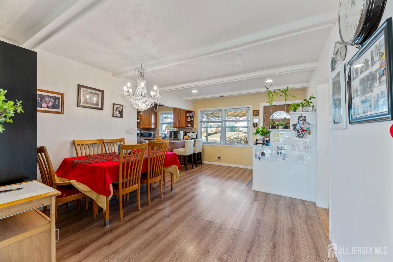 46 Runyon Avenue Edison, NJ 08817 - Photo 10 of 48 a living room with furniture a chandelier and pool view