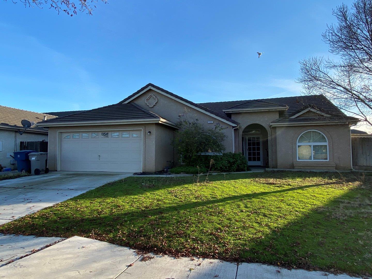 1431 Cardinal Street Los Banos, CA 93635 - Photo 1 of 10 a view of a house with a yard and garage
