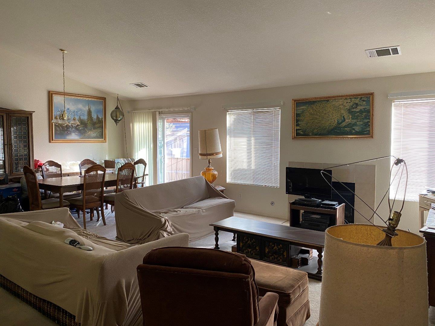 1431 Cardinal Street Los Banos, CA 93635 - Photo 4 of 10 a living room with furniture a flat screen tv and a fireplace