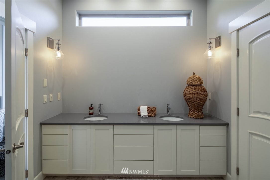 5999 Lawrence Road Everson, WA 98247 - Photo 22 of 40 a bathroom with a granite countertop sink and a mirror