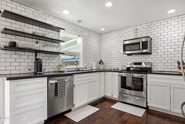 a kitchen with stainless steel appliances granite countertop a stove and a sink