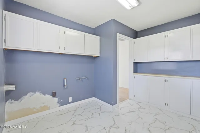 a view of a kitchen with white cabinets