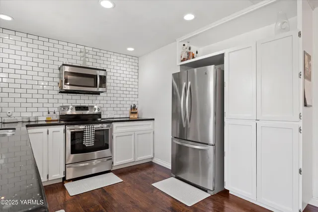 a kitchen with a refrigerator stove and microwave
