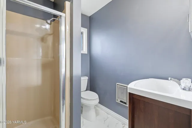 a bathroom with a toilet a sink and shower