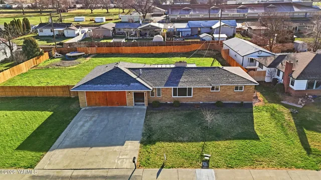an aerial view of a house with a yard basket ball court and outdoor seating
