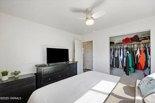 a room with a bed and a flat screen tv