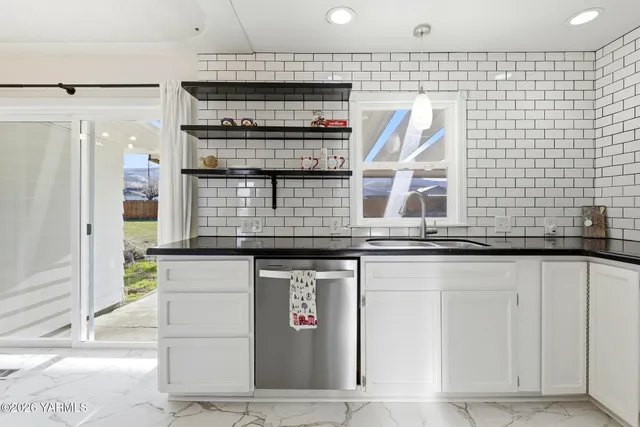 a kitchen with stainless steel appliances granite countertop a stove and a sink