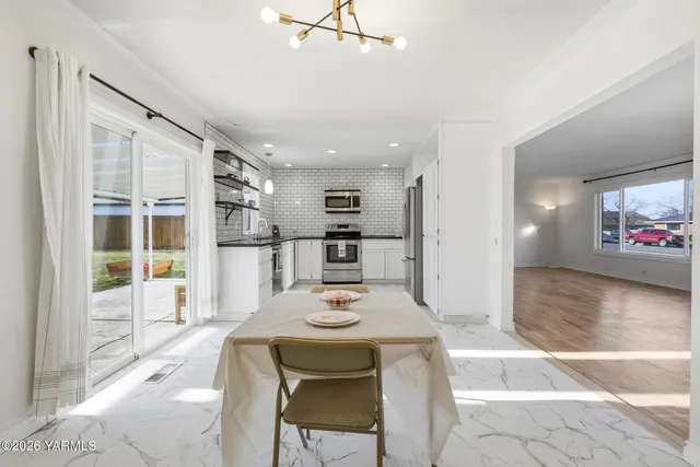 a kitchen with stainless steel appliances kitchen island granite countertop a refrigerator and microwave