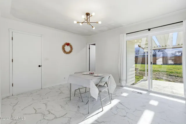 a view of a livingroom with furniture and floor to ceiling window