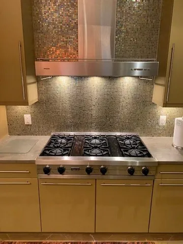 a stove top oven sitting inside of a kitchen