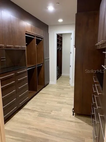 a room with wooden floor and electronic appliances