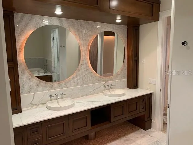 a bathroom with a double vanity sink and a mirror