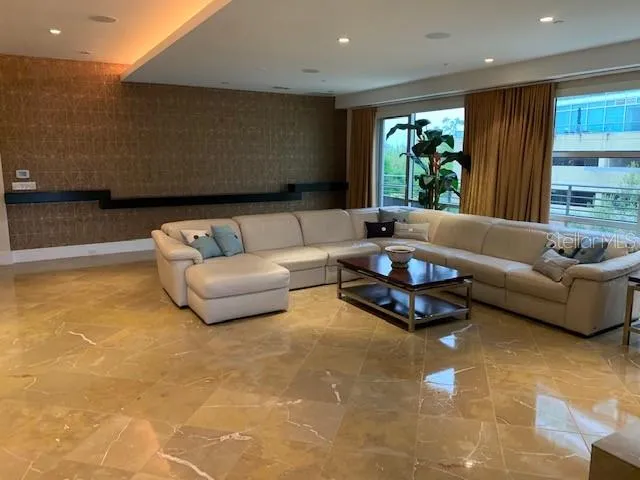 a living room with furniture and large windows