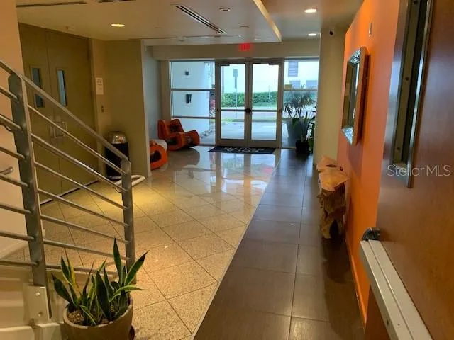 a hallway with sliding door and wooden floor