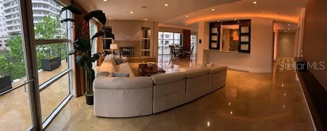 a living room with furniture and a floor to ceiling window