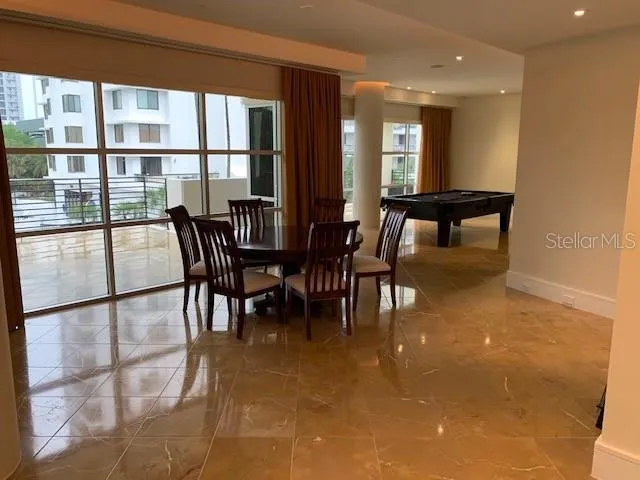 a view of a dining room with furniture and window
