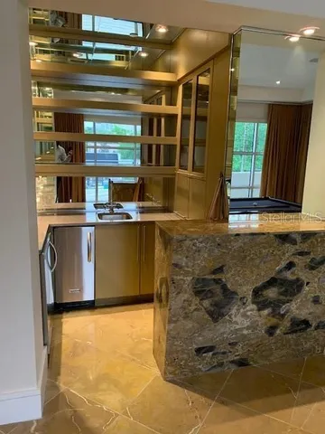 a view of a kitchen with stainless steel appliances granite countertop a stove and a refrigerator