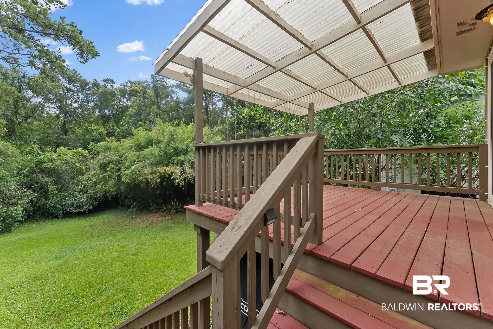 357 South School Street Fairhope, AL 36532 - Photo 35 of 44 Spacious outdoor deck featuring wood-finish flooring, a wood railing, and a translucent overhead covering