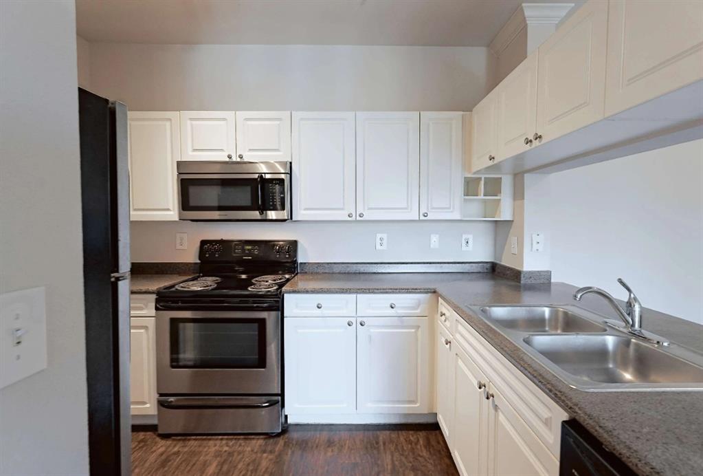 10505 I-35 Frontage Road South, Unit 2432 Austin, TX 78747 - Photo 14 of 22 a kitchen with stainless steel appliances granite countertop a stove microwave and sink