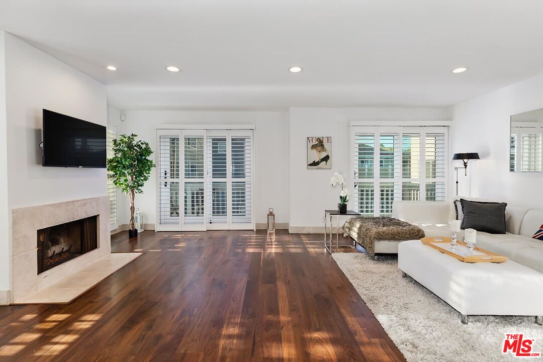 a living room with furniture fireplace and flat screen tv