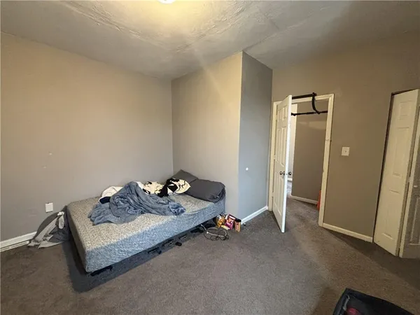 a bedroom with bed and window