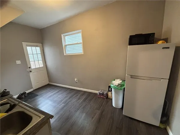 a view of a room with wooden floor and white cabinet
