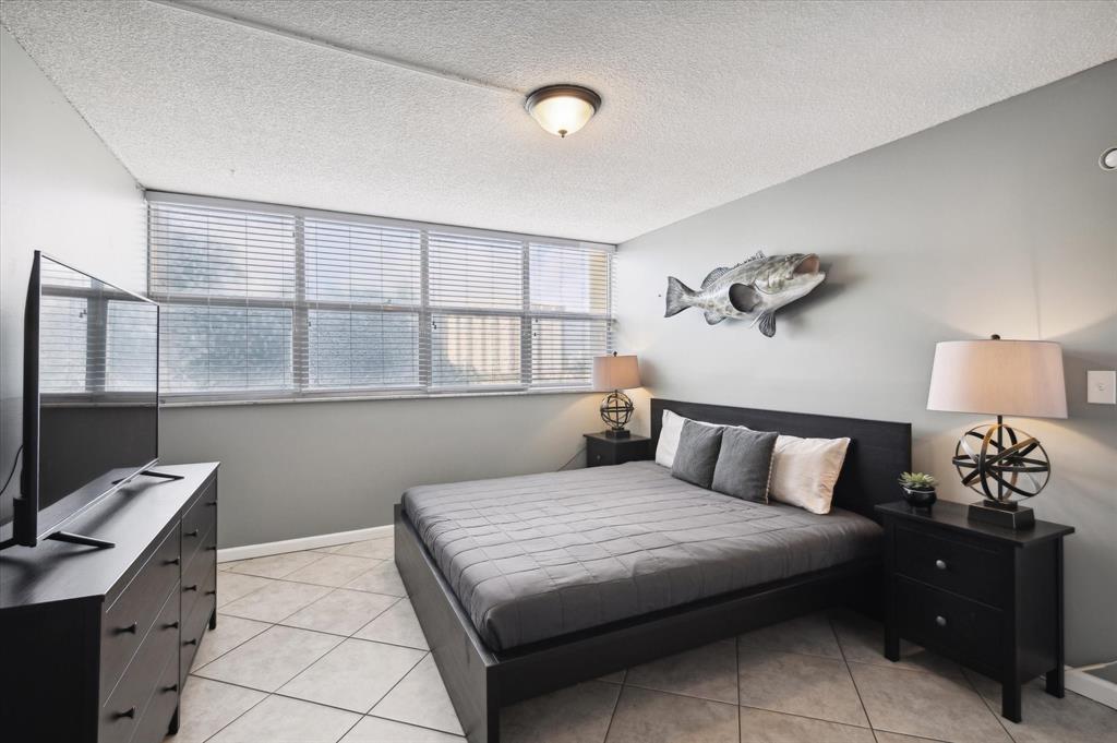 100 Golden Isles Drive, Unit 508 Hallandale Beach, FL 33009 - Photo 12 of 17 a bedroom with a large bed and a window