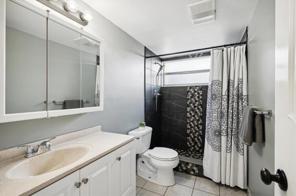 100 Golden Isles Drive, Unit 508 Hallandale Beach, FL 33009 - Photo 13 of 17 a bathroom with a sink a toilet and shower