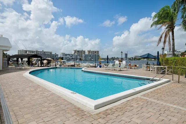 a view of swimming pool with outdoor seating