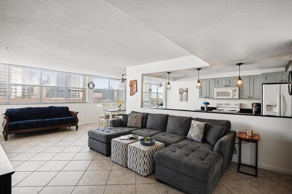 100 Golden Isles Drive, Unit 508 Hallandale Beach, FL 33009 - Photo 4 of 17 a living room with furniture and a couch