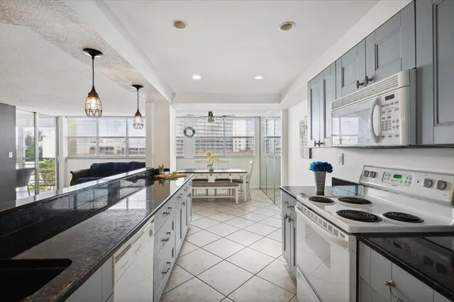 a kitchen with stainless steel appliances granite countertop a stove and a sink