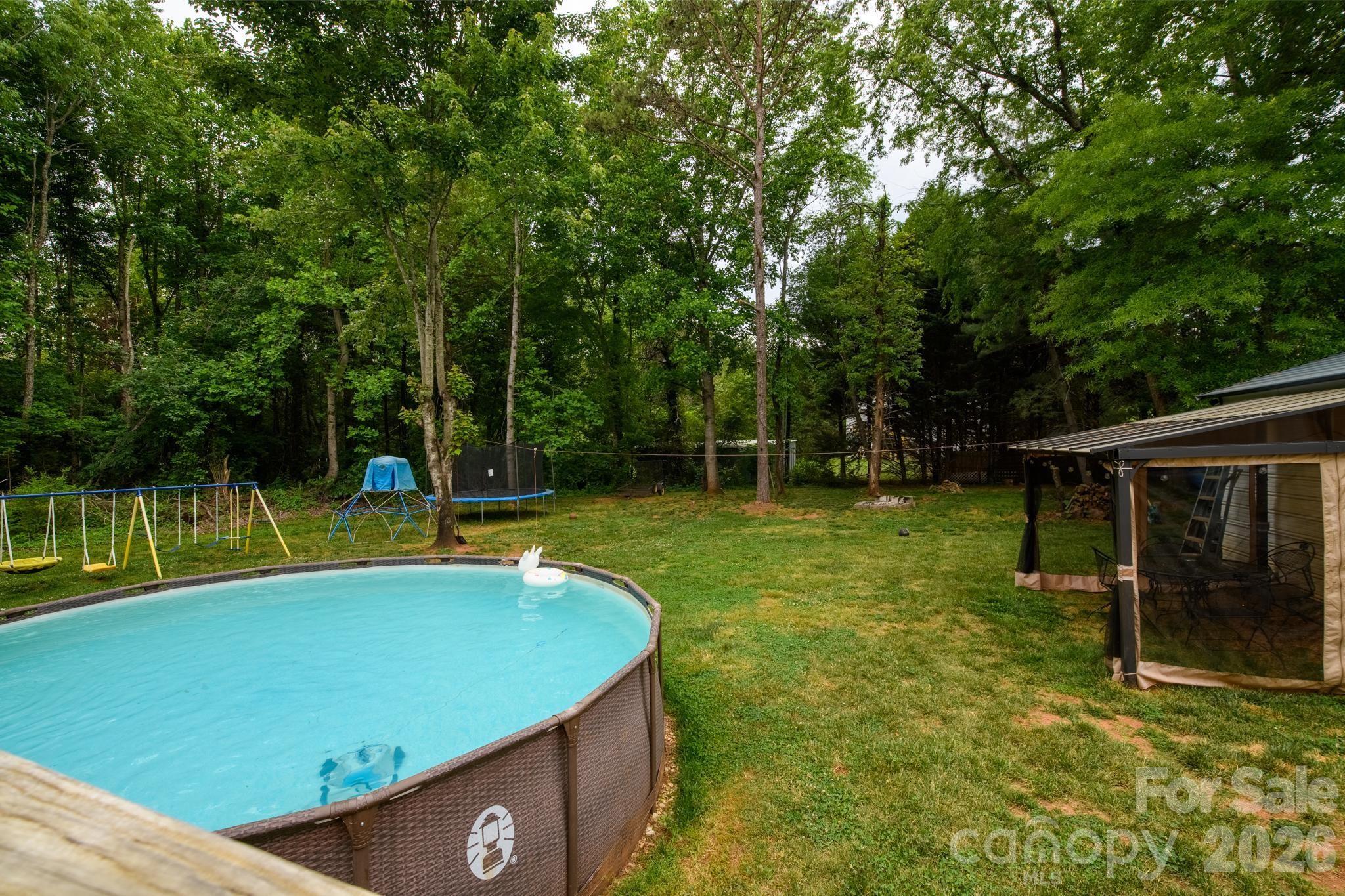 2308 Walt Arney Road Lenoir, NC 28645 - Photo 15 of 37 a view of a backyard with swimming pool and sitting area